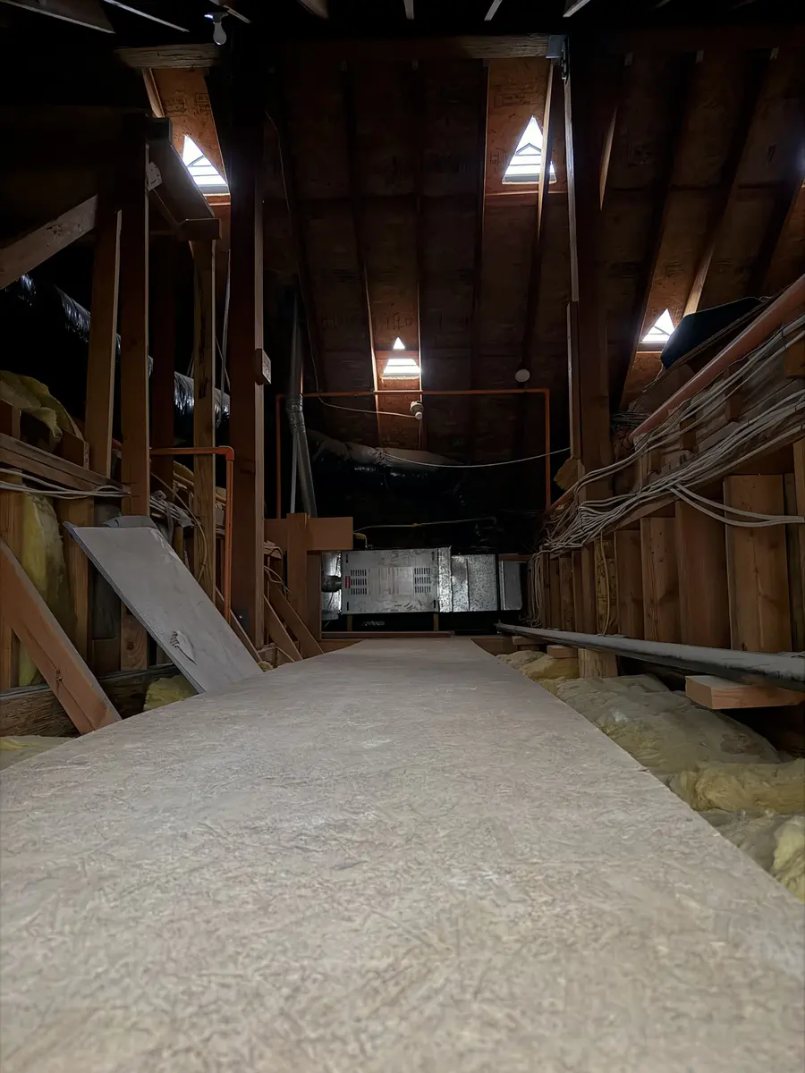 Chasing runs through the attic — the paths the new wiring rides.